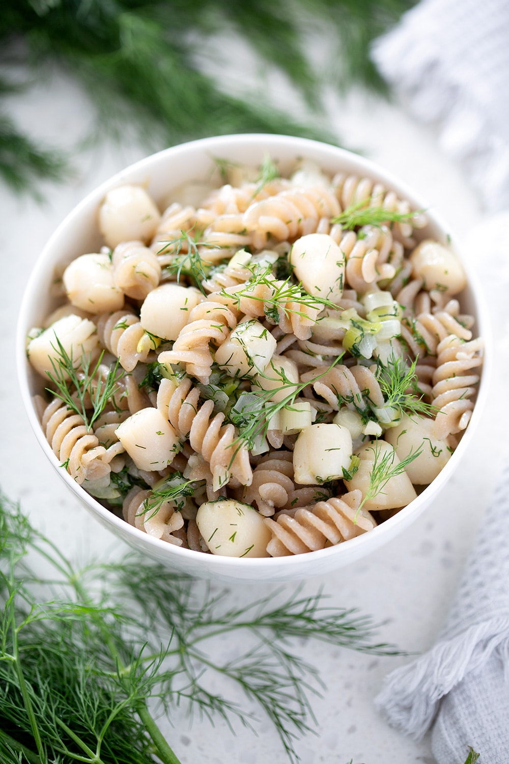 bowl of dill scallop AIP pasta with fusilli noodles