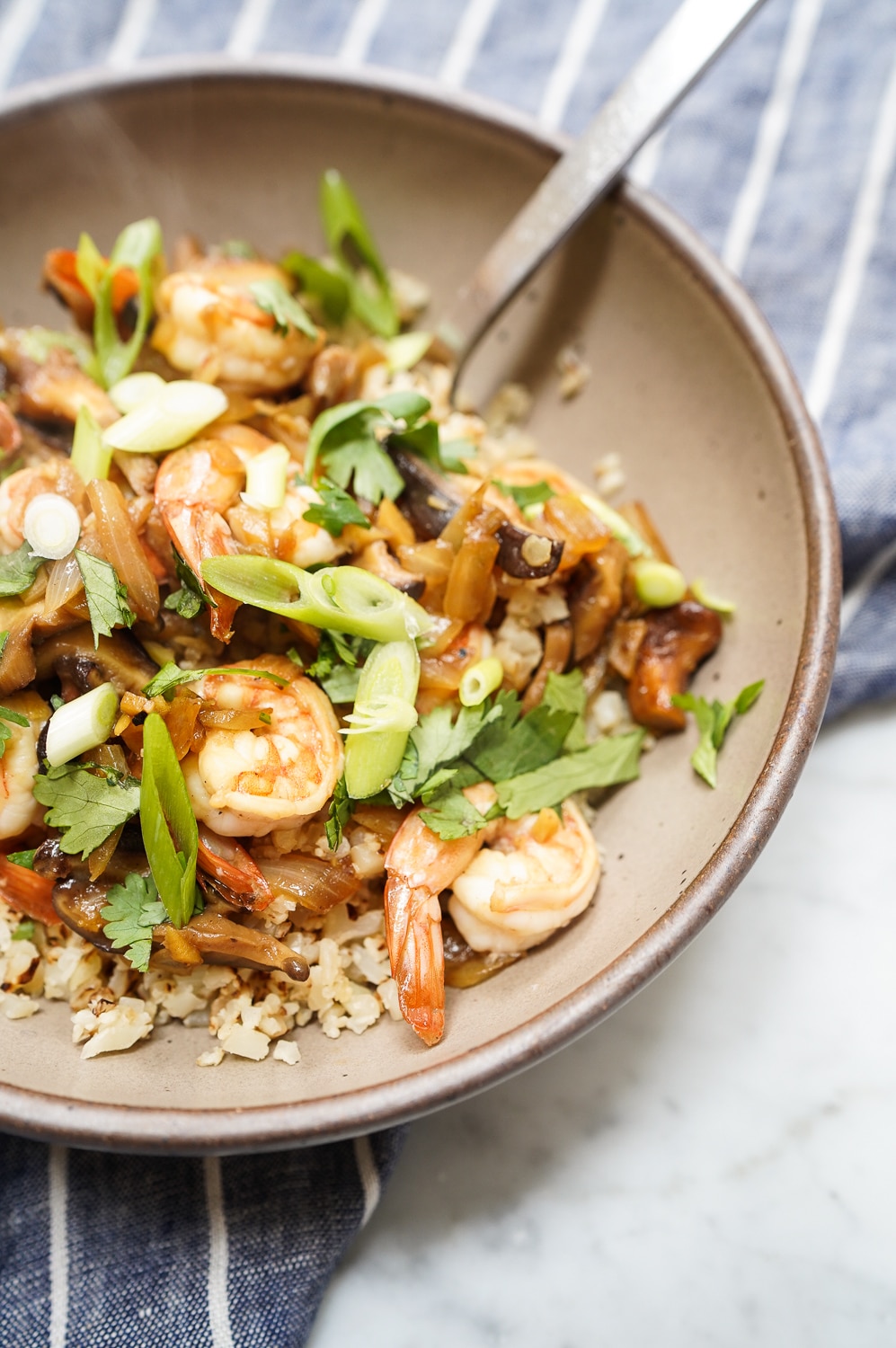 Cauliflower rice stir fry in bowl close up